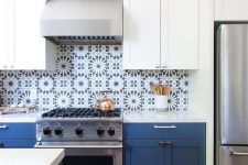 a fab two-tone kitchen with white and navy cabinets and bold blue Moroccan tiles on the backsplash is a fantastic idea