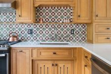 a light stained kitchen with a bright Moroccan tile backsplash and white stone countertops is a lovely idea to rock
