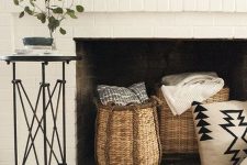 a cute whitewashed fireplace that is used for storage