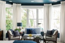 a stylish blue bedroom design with a seating area
