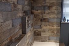 a modern bathroom clad with reclaimed wood look tiles, with white appliances and built-in lights is a stylish and cool idea