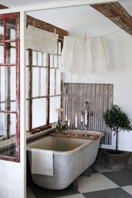 a shabby chic bathroom with shabby chic frames and wodoen beams, a concrete tub and corrugated stee, a potted tree is cool