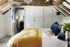 a small yet cozy attic bedroom design with rustic touches