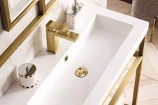 a stylish console sink with a console made of brushed brass and a white sink, a brushed brass faucet and a matching mirror for ultimate elegance