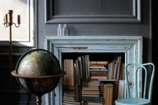 a vintage fireplace with a blue shabby chic mantel, books and a blue chair, a globe is a stylish and cool idea