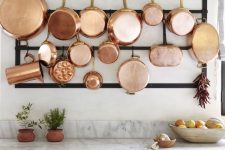 copper cookware displayed in the kitchen will make it very elegant, stylish and will give it a cozy and homey feel at the same time