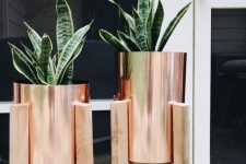 lovely copper planters in wooden stands are a gorgeous and stylish idea for any modern outdoor or indoor space