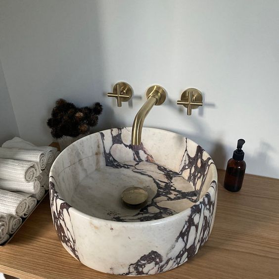 such an eye catchy stone round vessel sink will make a very refined and chic statement in any bathroom and will add interest to it