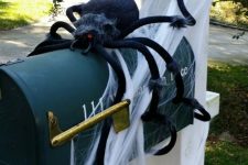 03 a black letter box on a pillar, with spiderweb and a large black spider is easy and fun Halloween decor that brings a Halloween feel