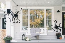 07 a house styled with giant black spiders looks scary and Halloween-like but still remains a farmhouse-style dwelling with an organic and natural feel