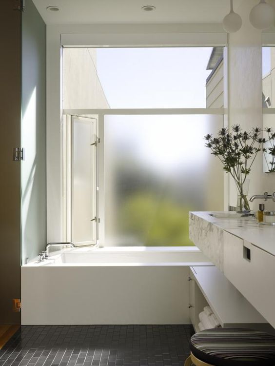 a stylish minimalist bathroom design with frosted glass window