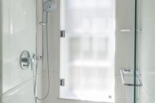 11 a sleek neutral shower space with a tall window covered with frosted glass, which is a smart and easy solution to go for
