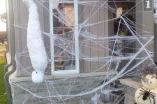 12 spiderwebs, a mummy, an oversized black spider and a small one on pumpkins is a cool idea to decorate a nook of your house or outdoors