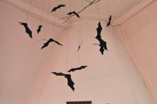 20 a black branch with bats hanging down is a cool and very easy decoration for Halloween that you can easily DIY