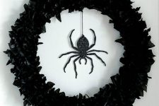 23  a black faux flower wreath and a black glitter spider is a stunning solution for decorating your front door and it looks elegant