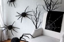 26 a nook with black branches and black spiders on the walls and on the floor is a lovely idea for Halloween, sitting in such a nook is spooky