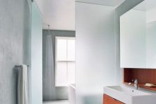 27 a plane of frosted glass separates the wet side of the bathroom, with the open shower, from the dry side