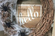 29 a stylish vine Halloween wreath with realistic spiderweb and black spiders is a cool solution for Halloween and it brings a Halloween feel at once