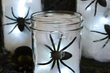 32 jars with white cotton, black spiders and lights are great as easy DIY Halloween lanterns are great to illuminate your space