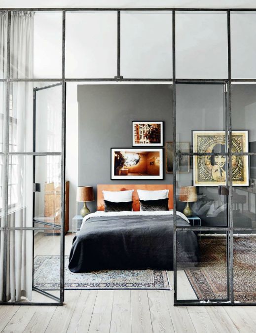 French doors with a modern look in black frames to separate the bedroom from the rest of the apartment in a delicate way