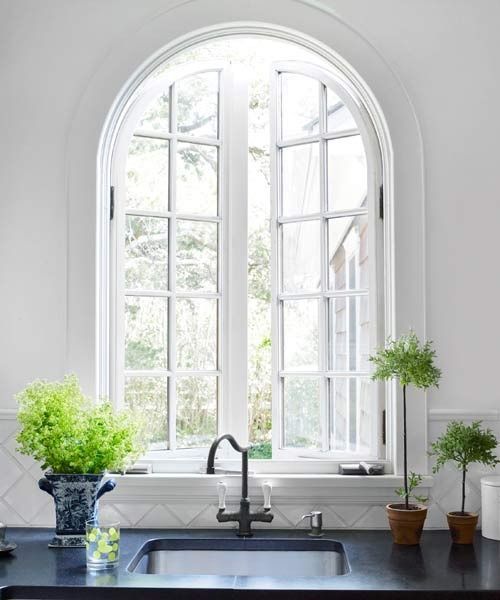 a beautiful arched window accents the farmhouse style and adds personality to the space