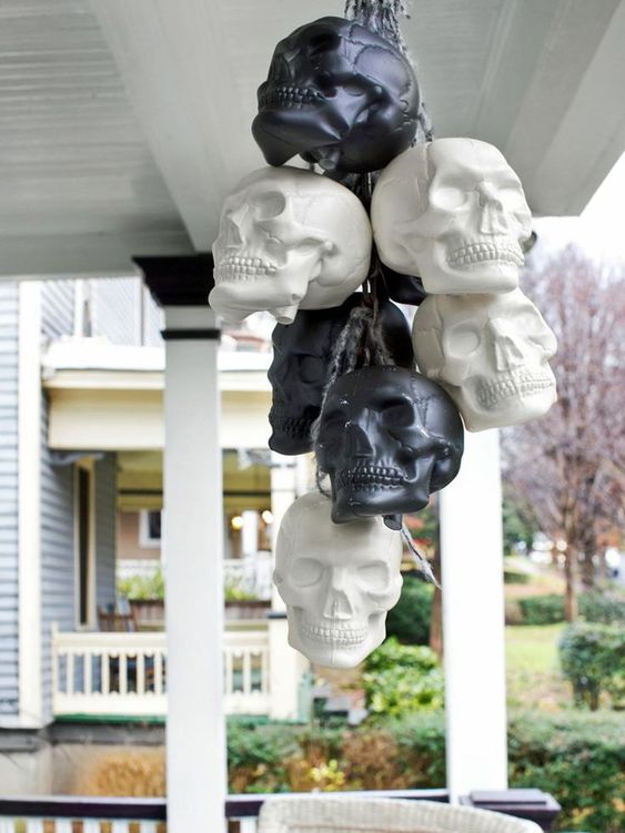 a bunch of black and white skulls is an easy idea to decorate indoors or outdoors for Halloween and looks cool