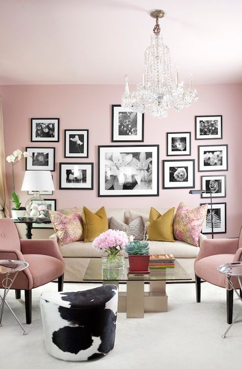 a cute pink living room with b&w gallery wall