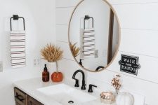 a fall farmhouse bathroom decorated with faux pumpkins, candles, dried blooms and wheat in a vase is a very cozy and lovely idea