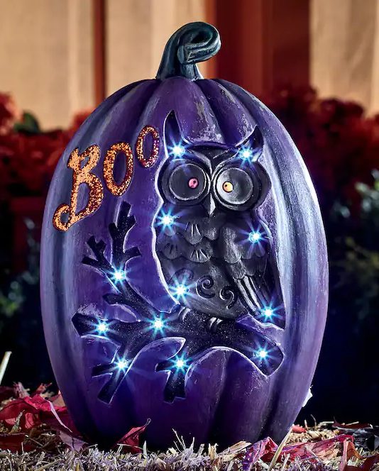 a jaw dropping purple Halloween pumpkin with lights and an owl plus BOO letters is a great decoration