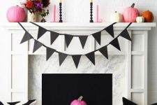 a modern bright Halloween fireplace with a black bunting, colorful pumpkins, bold blooms and candles plus graphic pillows