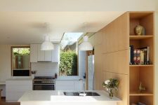 a neutral kitchen with modern furniture, with clerestory windows for more natural light and some large windows for the views