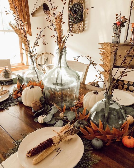 a relaxed rustic Thanksgiving tablescape with leaves, white and green pumpkins, corn cobs and dried blooms is amazing