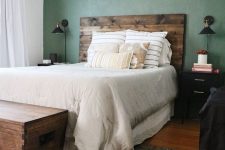 a cozy rustic bedroom with a green wall