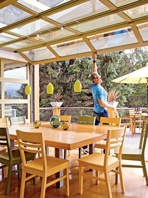 a simple and ann-natural dining space with light-stained dining set that can be opened up to outdoors with a garage door anytime