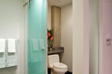 a turquoise frosted glass sliding door is a great idea for a powder room or to separate the toilet zone from the rest of the bathroom