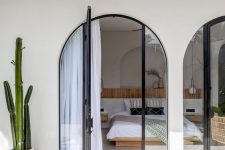arched glass doors leading to the bedroom with no windows provide enough light for the space keeping it private at the same time
