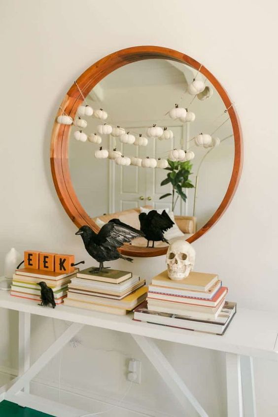 blackbirds, a skull, a garland with white pumpkins and some letters for modern and simple Halloween styling