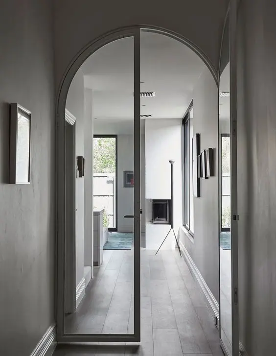 delicate white frame arched glass doors are amazing for a Scandinavian or contemporary home as they don't stand out too much