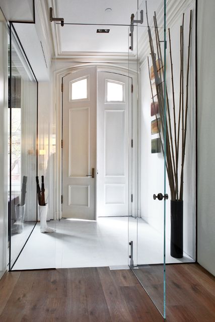 frameless glass doors are the best way to separate the spaces gently, it's a perfect solution for separating the entryway at once