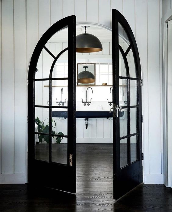 highlight the bathroom with black French arched doors like these ones, and it will get a super chic look