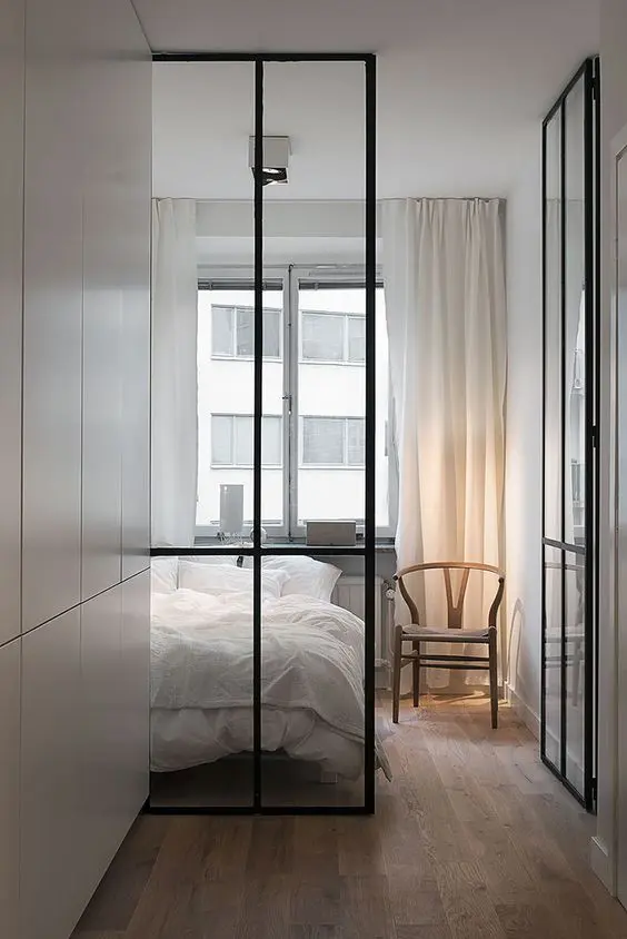 modern ceiling to floor metal frame glass doors act as space dividers but don't make the bedroom look small thanks to the glass