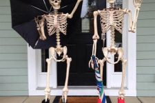 skeletons dressed in rubber boots, with an umbrella are great to rock on your Halloween porch