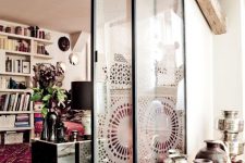 sliding glass doors covered with lace screens to support for a relaxed boho feel in the space are a very creative and cool solution
