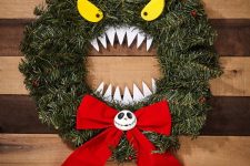 such a Halloween monster wreath of faux evergreens, eyes, teeth and a large bow can be used not only at Halloween but also at Christmas