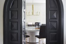 textural and carved black arched folding doors are a fantastic combo of modern and vintage – the design is vintage but the folding detail is pretty modern