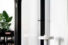 thick black frame arched doors will add some drama to the space and will keep the zones separated yet not too much
