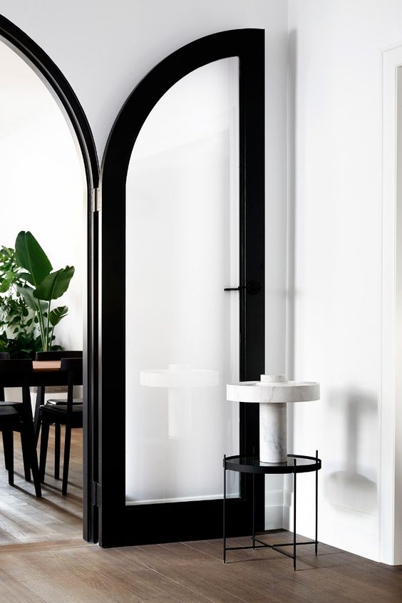 thick black frame arched doors will add some drama to the space and will keep the zones separated yet not too much