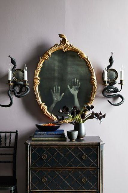 vintage wall candelabras covered with black snakes are adorable decorations for Halloween and can be easily made