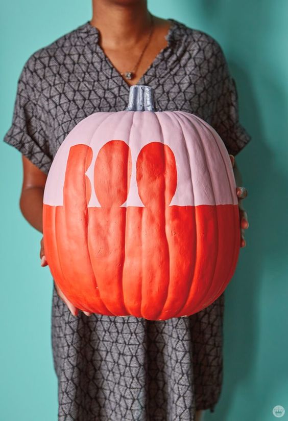 a matte pink and orange Halloween pumpkin with letters is a very cool and fresh idea to rock, simple and graphic