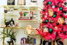 05 a pink Halloween tree with colorful ornaments and scary masks is a bold statement for your interior